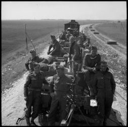 Ref: DA-01007-F
NZ troops, possibly of 21 NZ Battalion, on way forward by train. Taken 1941 by an official photographer.
