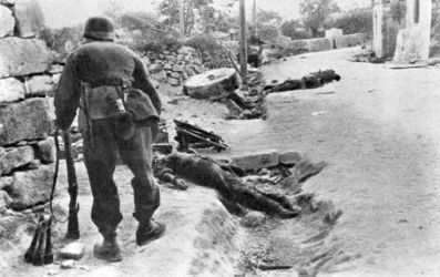 Ref: DA-12652-F
Street scene in Galatos, Crete, Greece, during World War 2, with bodies on the ground. Photographer unidentified.
This is a copy of an image in the book Gebirgsjager auf Kreta - Mountain Troops on Crete, by Major Flecker, prepared by Sepp Dobiasch, published by Wilhelm Limpert-Verlag, Berlin. Page 188. (Title information from back of file print DA-12643)