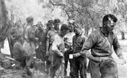 Date: May 1941 By: Tweeddale, R R, active 1941
Ref: DA-13085-F
Signals mess queue, New Zealand Division headquarters, Crete, Greece, May 1941, (photographed by R R Tweeddale?). The group includes ( Ken Hodge (seated), Noel Barrett, Johnson, Danny Calder, Sandy Ross, E V Jones (Baldy), Trebelco, Eric Bell Cliff Deverall, Scotty Clark, Ern and Mexted ? NB - List of names transcribed from back of file print )