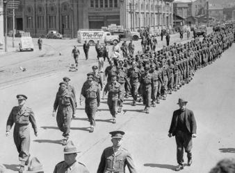 Date: between ca 1939-1945
Ref: 1/2-C-016251-F
Lt-Col James Henare, followed by RSM (Regimental Sergeant Major) Charlie Norris, leading the Maori Battalion towards Aotea Quay during a parade in Wellington circa 1939-1945. Photographer unidentified.