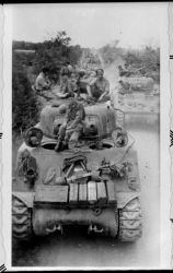 Ref: DA-14353-F
New Zealand 20th Armoured Regiment tanks and soldiers on the road to Trieste, Italy, during World War 2. Major Caldwell is sitting on the front tank's hatch. Denham is in the right hand tank. Photographer unidentified.
