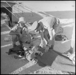 Date: 9 Jul 1942 By: Paton, Harold Gear, 1919-2010
Ref: DA-02547-F
Wounded German prisoner of war on a stretcher, Minqar Qaim, Egypt. Photograph taken on 9 July 1942 by H Paton. Wounded German P.O.W on a stretcher - Minqar Qaim, 1942